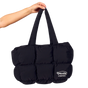 Black puffer bag held by a hand with Morlife logo on a white background